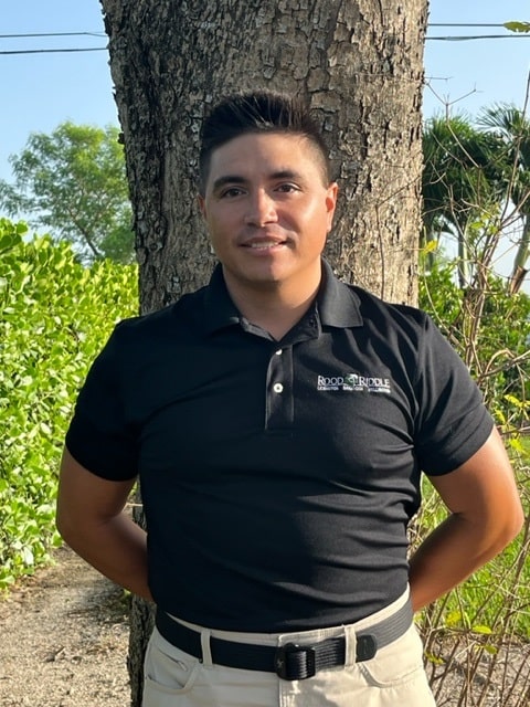 A man standing in front of a tree.